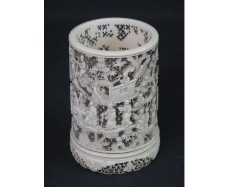 CHINESE CARVED IVORY CYLINDRICAL PIERCED NIGHT LIGHT HOLDER overall decorated with figures and buildings amongst foliage on a