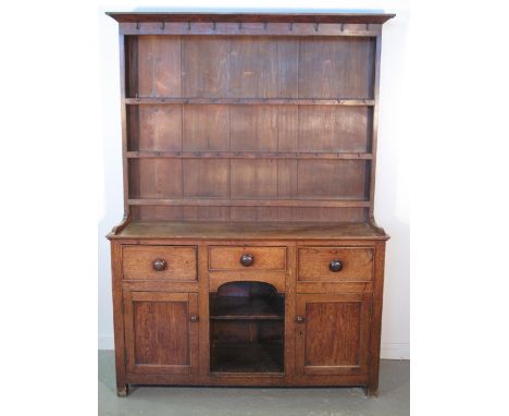 19th CENTURY WELSH OAK DOG KENNEL DRESSER having boarded three shelf rack back with original iron hooks, the base with three 