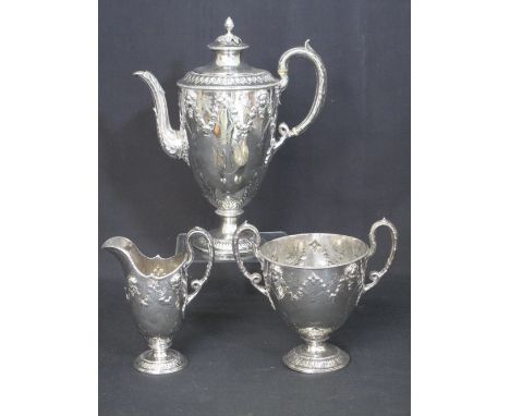 VICTORIAN SILVER THREE PIECE COFFEE SET comprising coffee pot, cream jug and two handled sucrier, overall decorated with mask