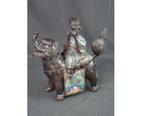 CHINESE BRONZED CHAMPLEVE ENAMEL FIGURE GROUP depicting a dog of Fo with a deity figure playing a flute.  12" high (30cm).  L