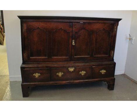 18th CENTURY WELSH OAK LOW PRESS CUPBOARD having moulded cornice over two ogee pointed arch panel doors, projecting base with