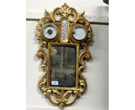 An 18th Century French style small giltwood Wall Mirror, with inset barometer, thermometer and hydrometer, decorated with C s