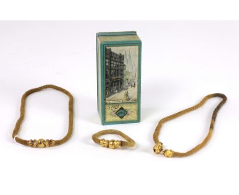 Jewellery: An unusual pair of Victorian mesh Necklaces, a matching Bracelet, each with finely engraved gold dragon heads with