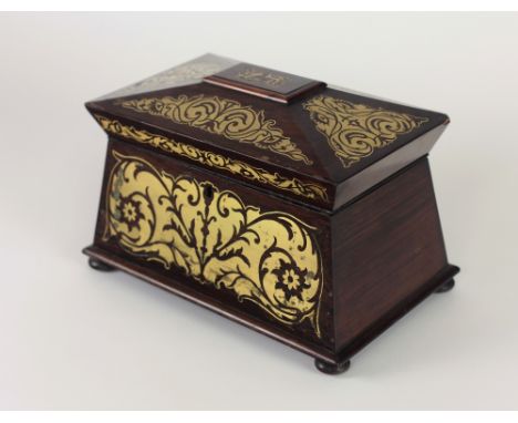 A Regency casket shaped rosewood Tea Caddy, the top with brass inlaid decoration and with a similarly decorated front on bun 