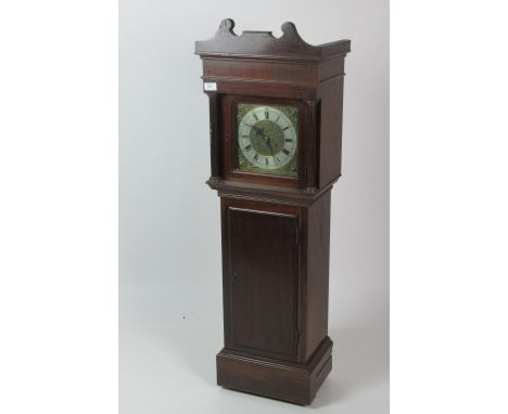 An unusual Georgian style mahogany miniature Grandfather Clock, the shaped pediment over a brass decorated dial on plinth bas