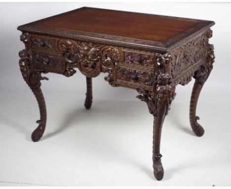 A late 19th Century carved Chinese Export wooden Desk, the plain top with blind fretwork border, and with a beaded edge, the 