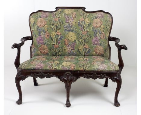 An 18th Century Irish style mahogany two seater Settee, with shaped and scroll back, with S scroll arms terminating with eagl