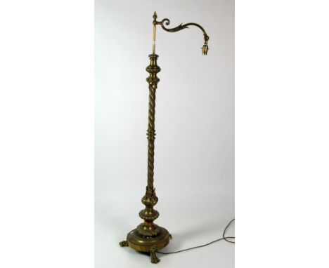 A heavy brass Victorian Lamp Standard, with outstretched arm on a barley twist design pillar, circular platform base on paw f