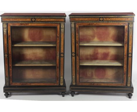 A pair of Victorian ormolu mounted ebonised Vitrines, the plain tops over a decorative inlaid walnut frieze, the glazed doors