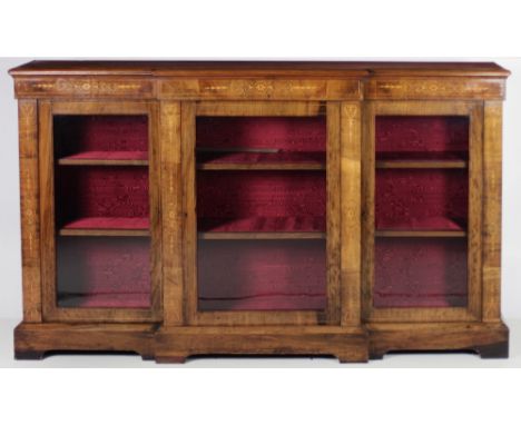 A Victorian marquetry inlaid walnut breakfront Side Cabinet, the moulded rim above three glazed panel doors raised on a plint