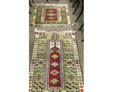 Two light ground Eastern Rugs, one 91cms x 152cms (36" x 60") with large yellow border; the other 99cms x 101cms (39" x 40") 