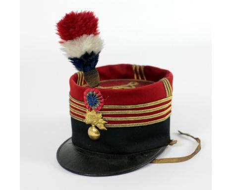 A 19th Century French Army "Kepi" Hat, the main leather body with red material top decorated with gilt material, mounted with