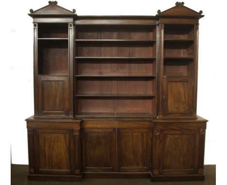 A fine quality William IV Irish inverted Breakfront Bookcase, the central plain cornice flanked by triangular pediments, the 