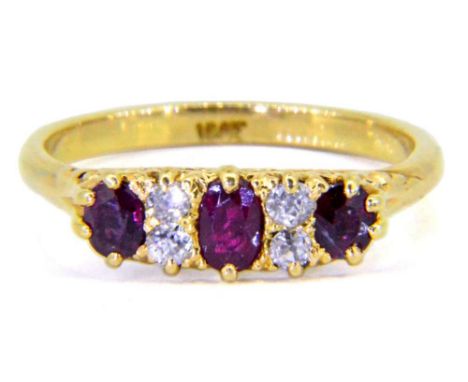 A late 19th Century gold, ruby and diamond seven-stone ring: with three oval rubies separated by pairs of circular diamonds, 