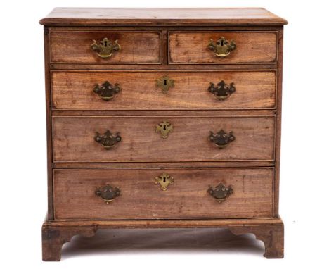 An early 19th Century mahogany chest of drawers of small size: comprising two short over three long graduated cock beaded dra