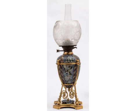 A Doulton Lambeth stoneware oil lamp: the base and reservoir decorated by Mark V. Marshall with panels containing fairy folk,