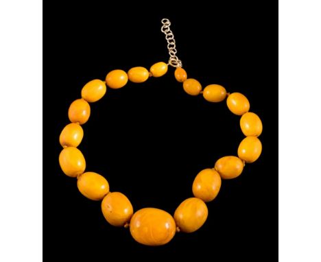 A graduated amber bead single-string necklace: with 19 individually knotted, oblong beads graduating from 11mm long to 30mm l