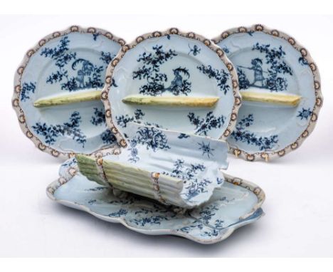 Emille Galle, Nancy. A late 19th century majolica asparagus service: painted in blue in Moustiers faience style with figures 