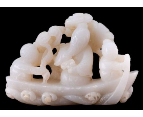 A Chinese carved jade group: of three figures seated in a boat, pine trees in the background, 11cm. wide, 8cm. high.