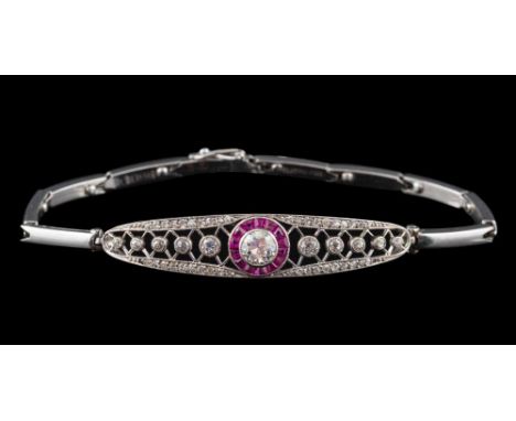 An early 20th Century platinum, ruby and diamond mounted bracelet: with central circular brilliant-cut diamond approximately 