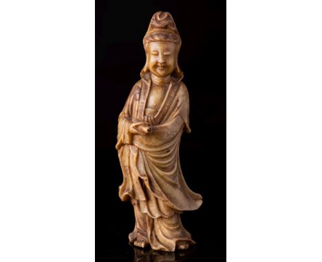 A Chinese carved soapstone figure of Guanyin and a soapstone brush washer: Guanyin wearing flowing robes and holding a scroll