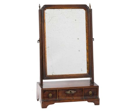 An 18th Century walnut and partly gilt swing frame platform toilet mirror:, the rectangular plate within a gilt foliate slip 