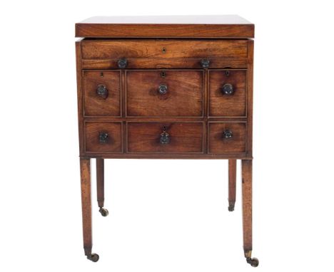 An early 19th Century mahogany enclosed dressing table:, the hinged top enclosing a fitted interior with adjustable rachetted