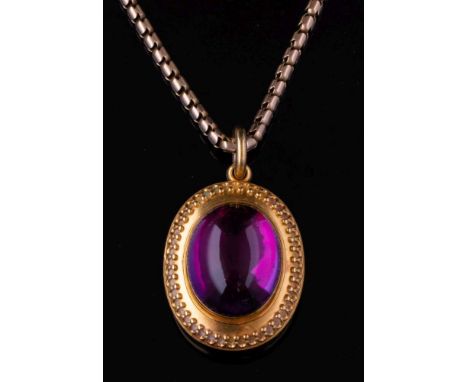 A Victorian gold and cabochon amethyst pendant locket on chain: with central oval cabochon amethyst approximately 18mm long x