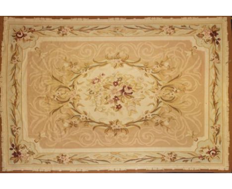 An Aubusson tapestry:, the cream and beige field with a central bouquet of flowers and foliage, within a floral foliate carto