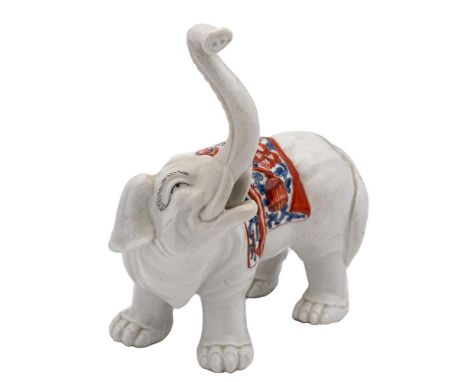 A Chantilly-style porcelain elephant: modelled with trunk raised and wearing a saddle cloth decorated in the Kakiemon manner,