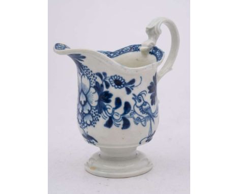 A Liverpool [Philip Christian] blue and white milk jug: of helmet shape with 'biting snake' handle, painted with a bird perch