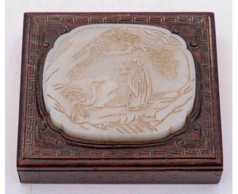 A Chinese pale celadon jade plaque: of foliate rectangular form, carved with Shou Lao holding a lingzhi spray in a rocky land