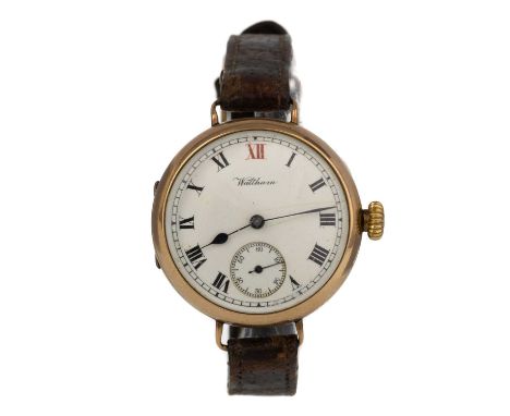 WALTHAM, NINE CARAT GOLD TRENCH WATCH  the round enamel dial with Arabic hour markers, 32mm case, on a brown leather strap  M