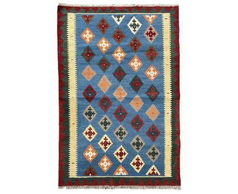 Kilim rug, light blue ground field decorated with multiple stepped lozenges, three geometric border bandsDimensions: Length/W