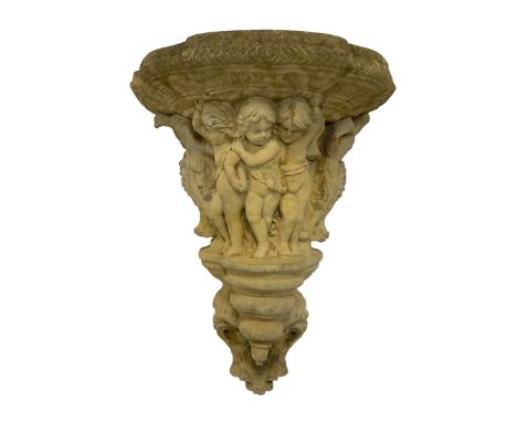 Classical design cast stone corbel, the relief body decorated with mischievous Putti flanked by eagles, the terminal decorate