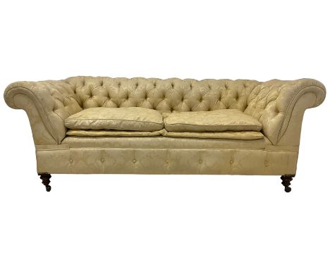 Early 20th century mahogany framed Chesterfield sofa, scrolled drop-arms, upholstered in light gold buttoned Damask floral pa