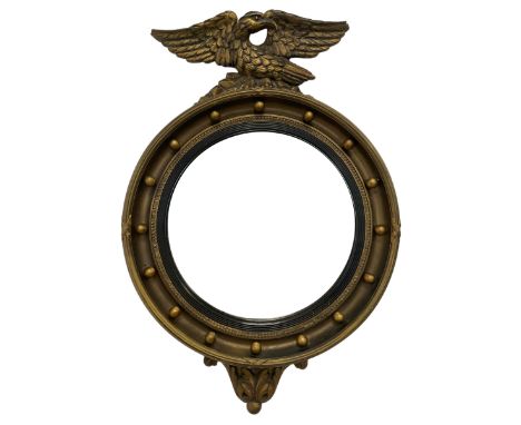 Mid-20th century Regency design gilt convex wall mirror, with eagle pediment over ribbon moulded frame with spherical mounts,
