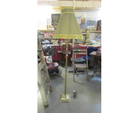 A brass standard lamp with reeded column complete with shade.  (Collect only).