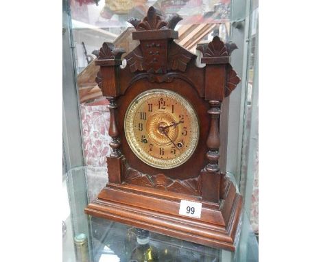 An early 20c mahogany mantle clock with gilded brass face by the Ansonia clock co New York, USA