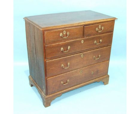 An antique oak chest of two short and three long moulded drawers, on bracket feet, 98cm wide, 94cm high.