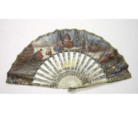 An 18th century ivory and paper fan, the guards and sticks pierced and carved, overlaid in silver and gold and backed with mo