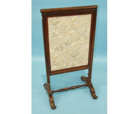 An early-19th century rosewood fire screen, the lift-up screen with later fabric covering, 50cm wide, 93cm high.