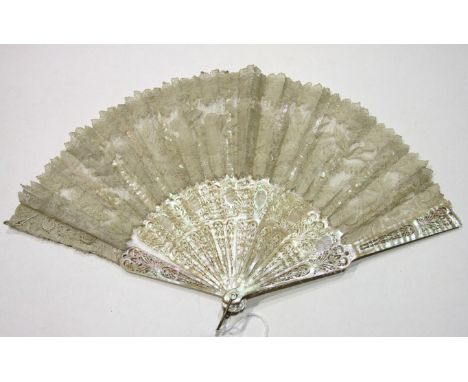 A 19th century mother-of-pearl and lace fan, the guards and sticks pierced and carved with scrolls, flowers and lattice panel