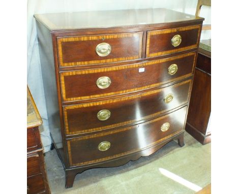 A Georgian mahogany and satinwood-banded bow-fronted chest of two short and three long drawers, on splayed bracket feet, 104c