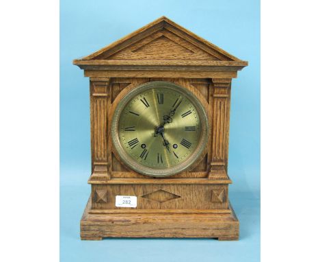 An oak mantel clock of architectural form, with brass dial and gong-striking movement stamped 'W & H Sch Winterhalder & Hofme