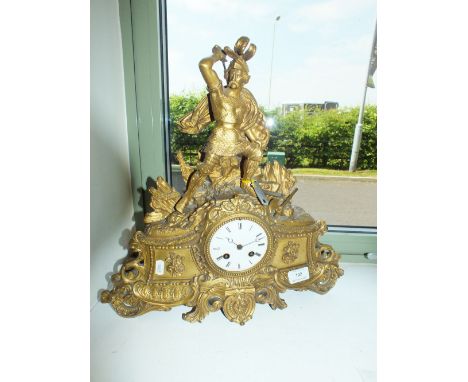 A French gilt metal mantel clock, the Rococo style case surmounted with a figure of a warrior