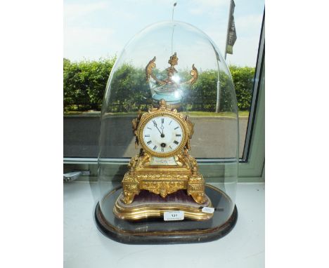 A French gilt metal and porcelain mantel clock with glass dome and stand