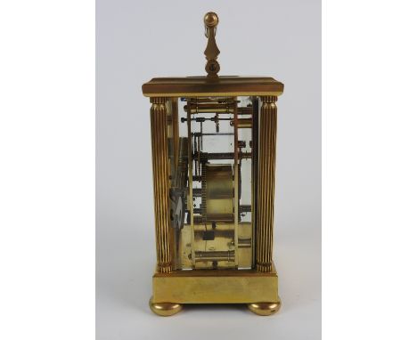 A brass carriage clock, the 2.5 inch white enamel dial with ring of Roman numerals over a subsidiary alarm dial, striking on 