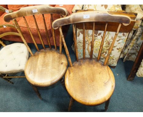 A pair of stick back kitchen chairs with circular seats 