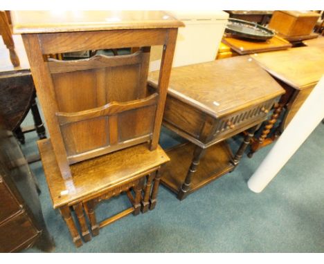 A 20th century oak two section magazine rack along with a mid 20th century nest of three oak occasional tables, a reproductio
